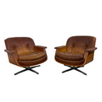 Pair of vintage cognac leather swivel lounge chairs by Eugen Schmidt