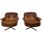 Pair of vintage cognac leather swivel lounge chairs by Eugen Schmidt