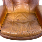Pair of vintage cognac leather swivel lounge chairs by Eugen Schmidt