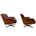 Pair of vintage cognac leather swivel lounge chairs by Eugen Schmidt