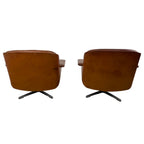 Pair of vintage cognac leather swivel lounge chairs by Eugen Schmidt