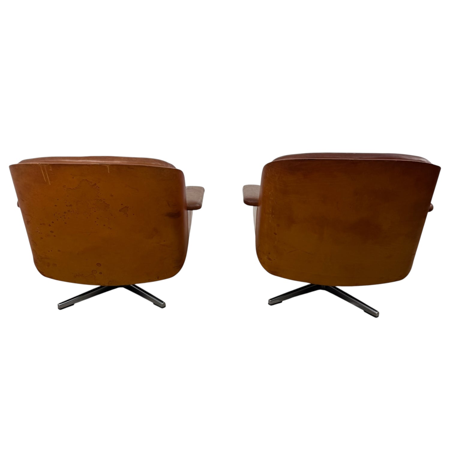 Pair of vintage cognac leather swivel lounge chairs by Eugen Schmidt