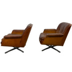 Pair of vintage cognac leather swivel lounge chairs by Eugen Schmidt