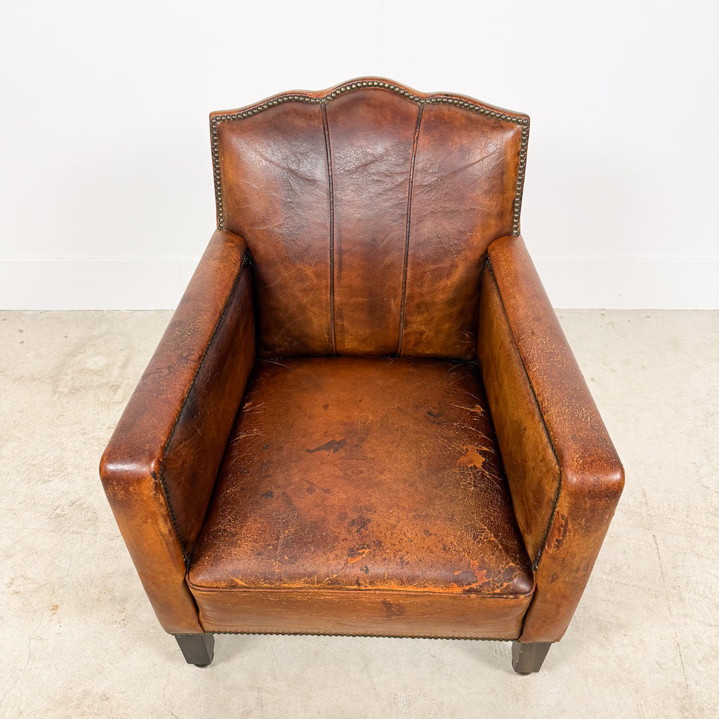 Antique cognac leather club chair with moustache back