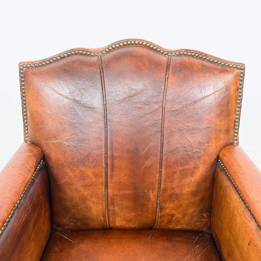 Antique cognac leather club chair with moustache back