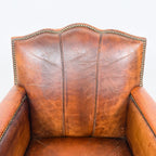 Antique cognac leather club chair with moustache back
