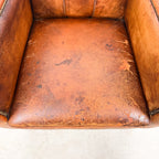Antique cognac leather club chair with moustache back