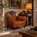 Antique cognac leather club chair with moustache back
