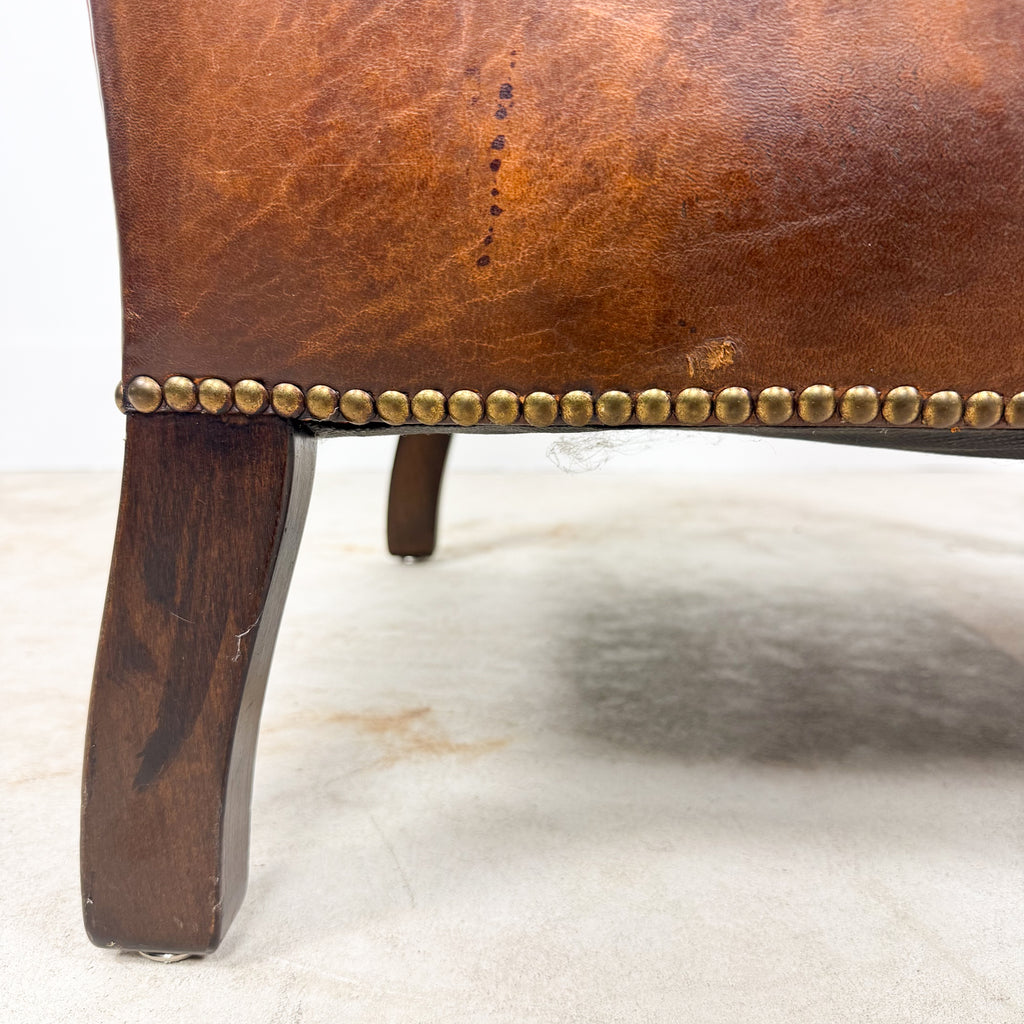Antique cognac leather club chair with moustache back