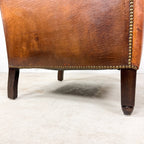 Antique cognac leather club chair with moustache back