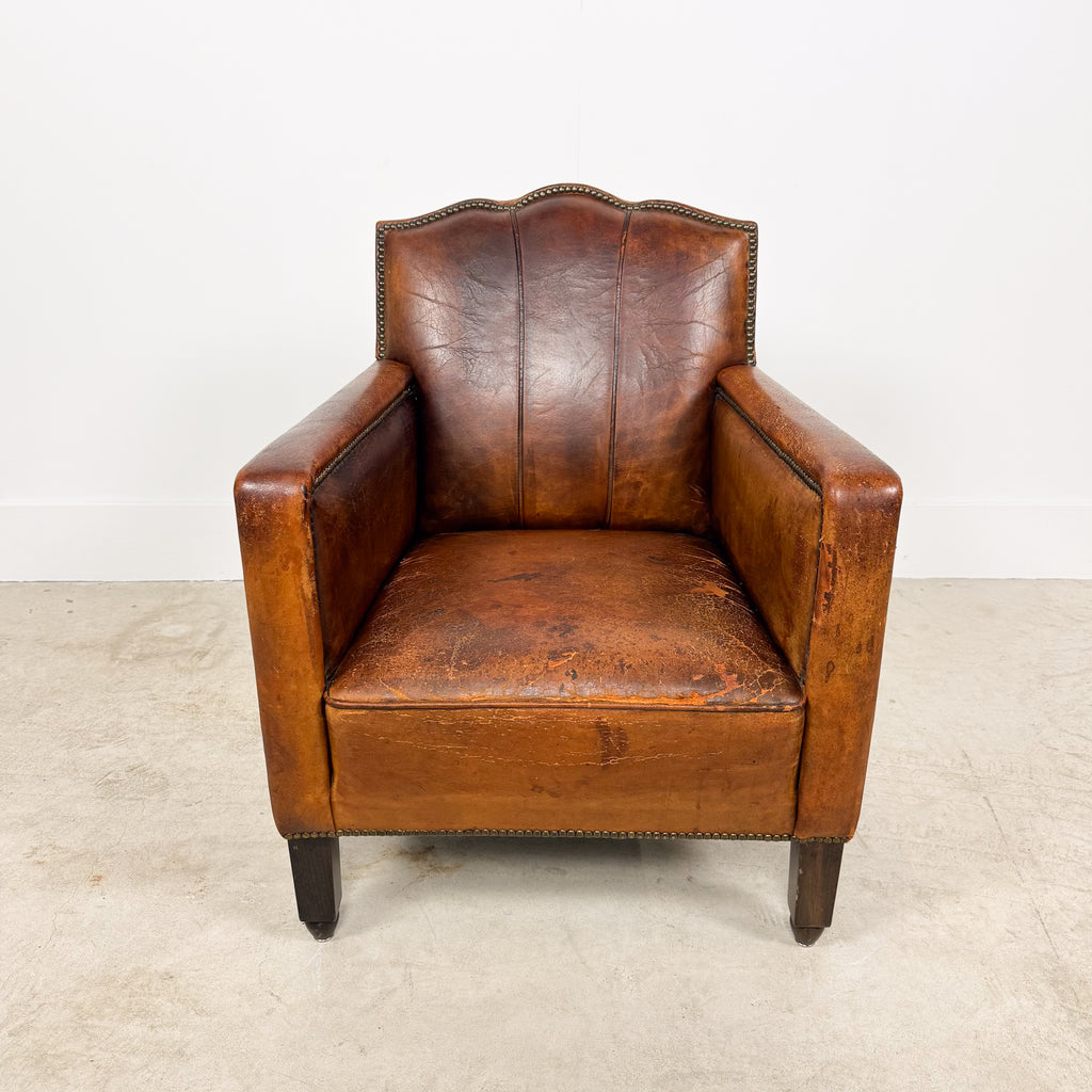 Antique cognac leather club chair with moustache back