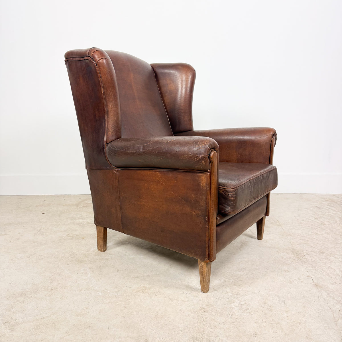 Vintage Brown Leather Wingback Armchair with Aged Patina