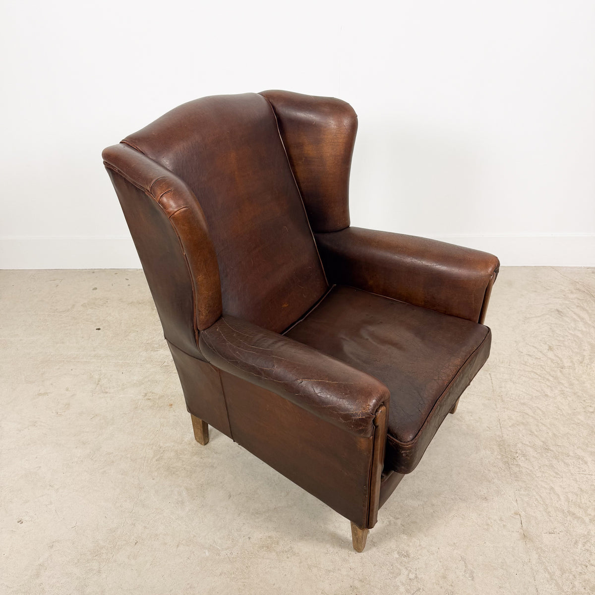 Vintage Brown Leather Wingback Armchair with Aged Patina