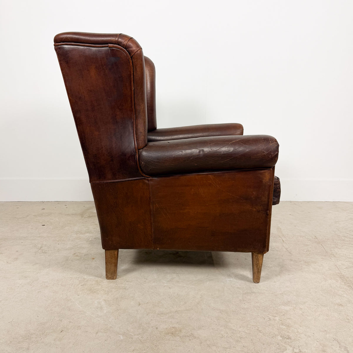 Vintage Brown Leather Wingback Armchair with Aged Patina